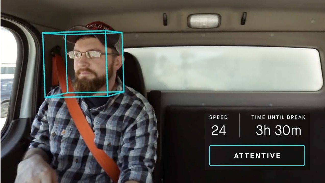 handsomemaledriversittinginacarandsmiling-selective-2