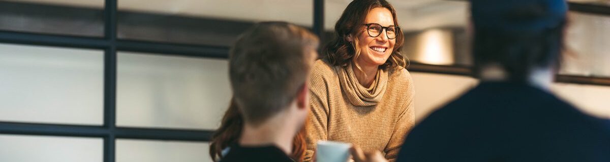 Group,Of,Colleagues,Engages,In,A,Dynamic,Discussion.,A,Confident